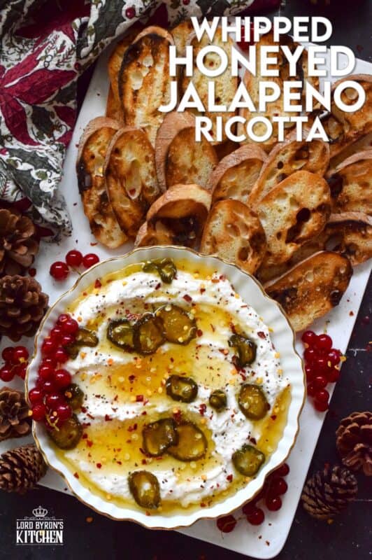 When you whip ricotta with garlic, onion, oregano, and sour cream, not only is the flavour incredible, but the texture is silky smooth.  Topped with homemade Jalapeno Honey, this dip is cool and spicy at the same time.  Serve with your favourite crackers and bread. #ricotta #appetizer #spread #dip #cheese #honey #jalapeno