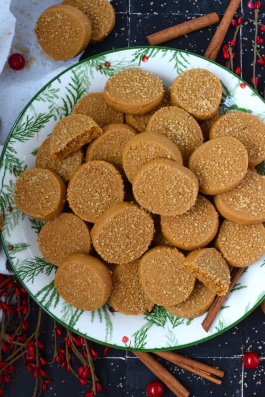 With a slightly crispy outer edge and a chewy center, Cinnamon Ginger Cookies are topped with a sprinkling of caramelly turbinado sugar.  These cookies are warming to the taste because of the mild heat produced by the cinnamon and ginger.  Serve these with hot tea or coffee for a delightful little treat! #molasses #cinnamon #ginger #cookies