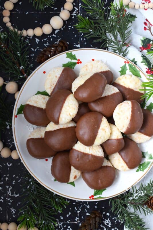 These no bake Coconut Cream Cheese Cookies require only four ingredients and about twenty minutes of your time! They are soft and chewy with just the right amount of sweetness that is well balanced with the addition of the cream cheese.  Make these cookies ahead of time and store them in your freezer! #sweetened #coconut #nobake #cookies #creamcheese #chocolate