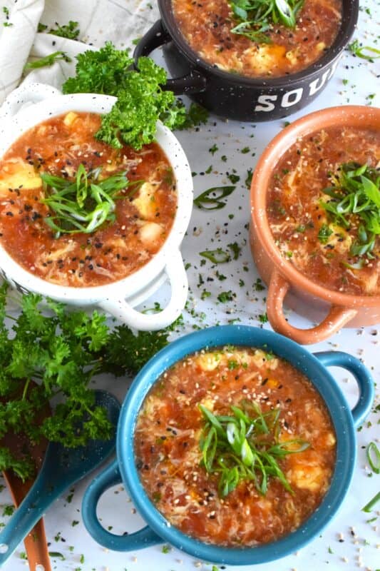 This quick and easy savoury Tomato Egg Drop Soup is prepared from start to finish in about 20 minutes! Better than the soup they serve at your favourite Chinese restaurant, and with an optional splash of hot sauce, the cozy and warm soup is hearty and healthy too! #asian #soup #eggdrop #vegetarian #eggs