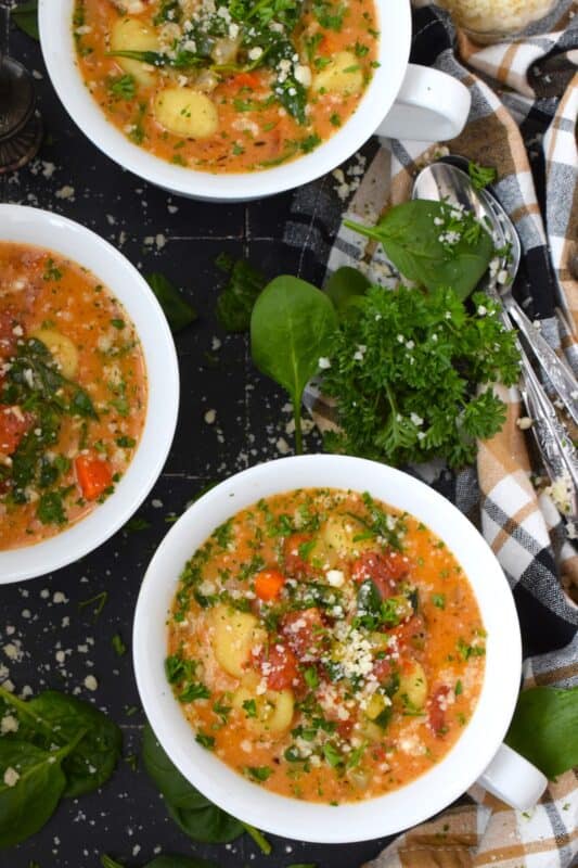 Creamy Gnocchi Soup is perfect for those nights when you want something warm, cozy, and filling for dinner but can't decide between pasta or soup!  This soup has it all - lots of vegetabless, a thick and creamy broth, soft and pillowy pasta, and parmesan too! #gnocchi #soup #spinach #creamy #pasta